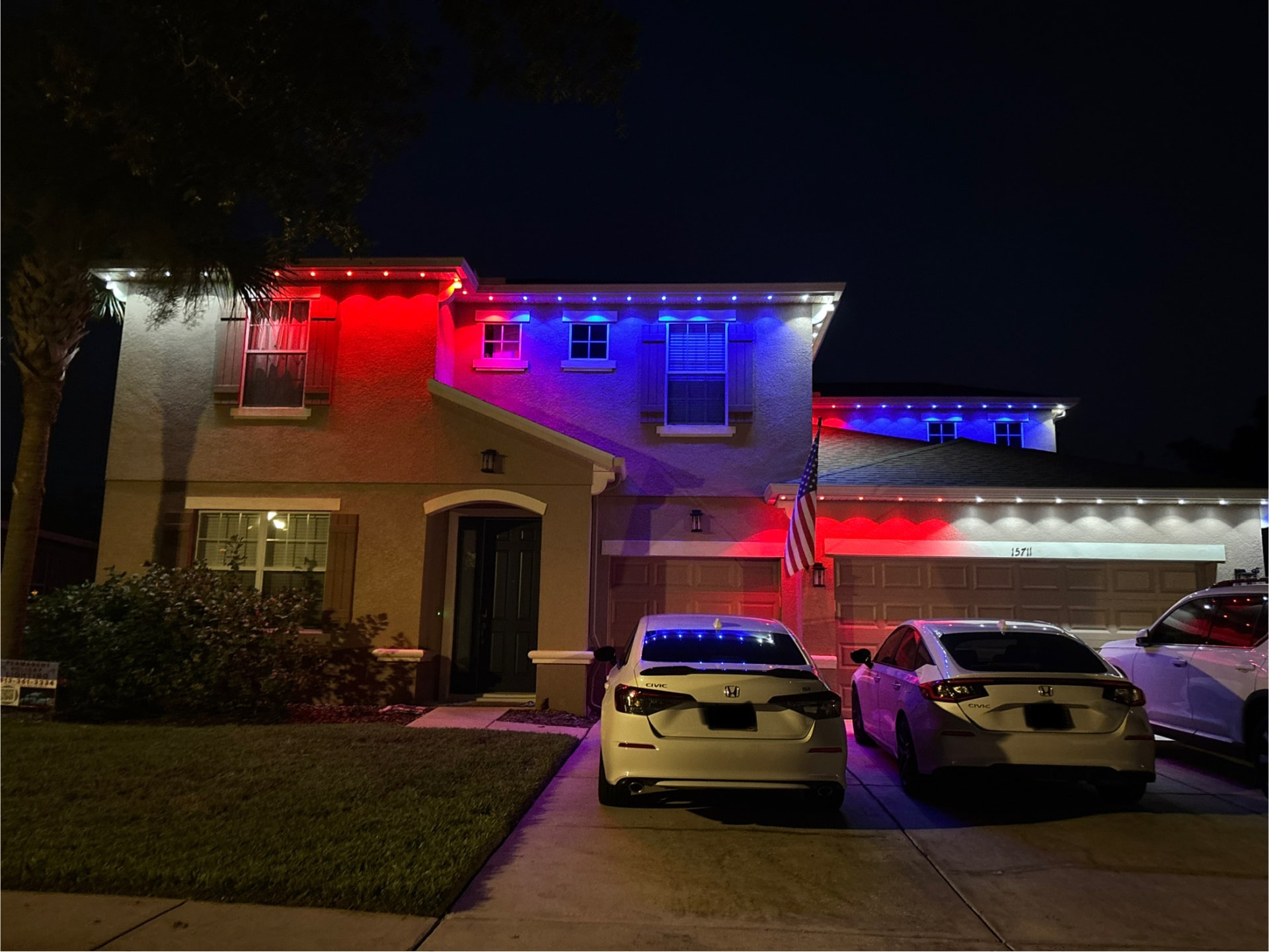 Two-story Florida home lit in red, white, and blue permanent LED lighting